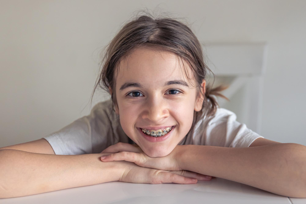 Girl with braces resting her chin on her hands