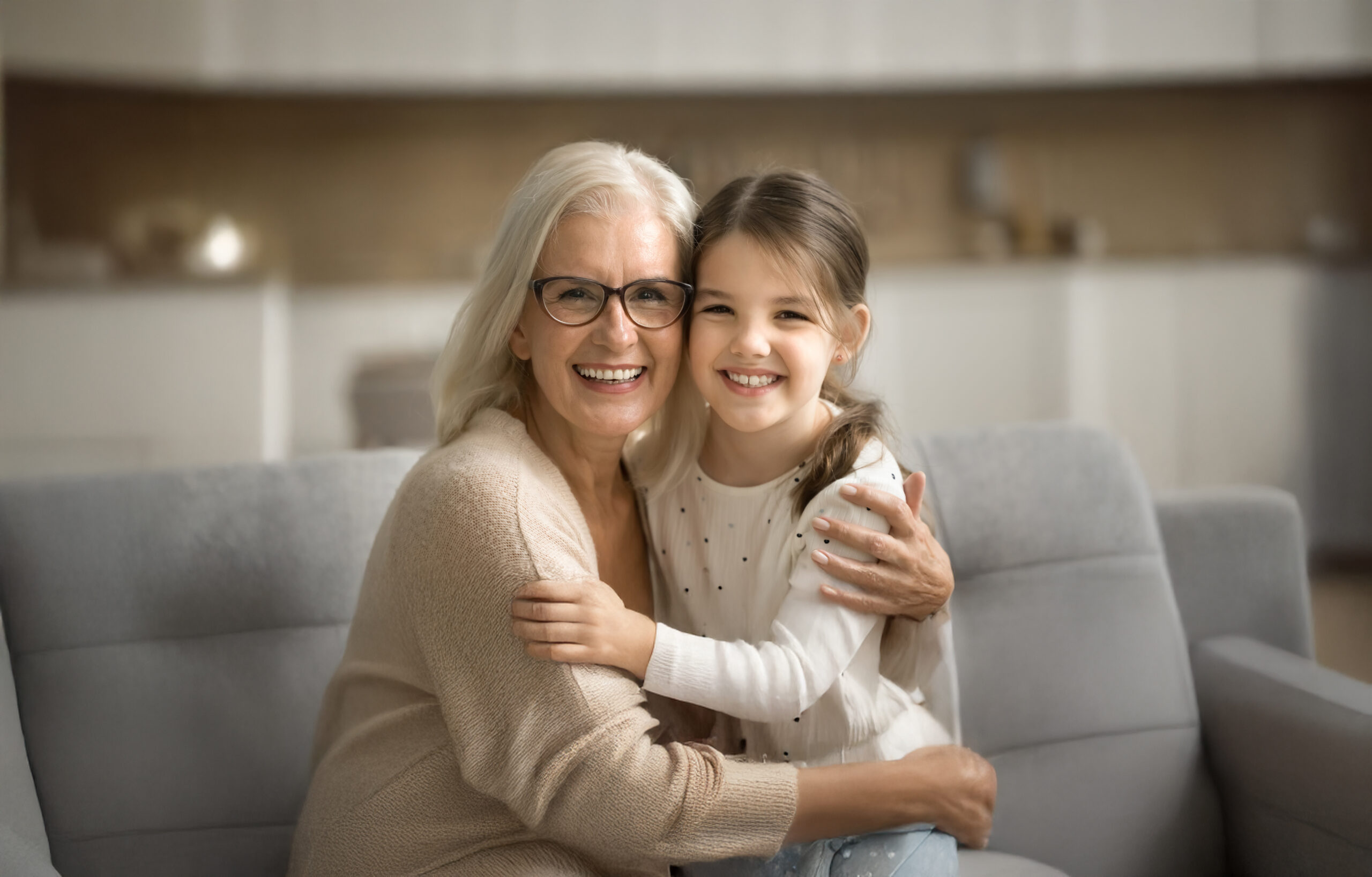 Cheerful Senior Grandmother And Happy Little Granddaughter Home Family Portrait
