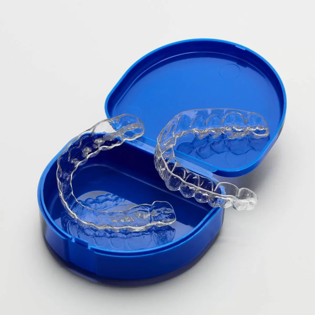 Set of clear plastic Essix Retainers in a blue case